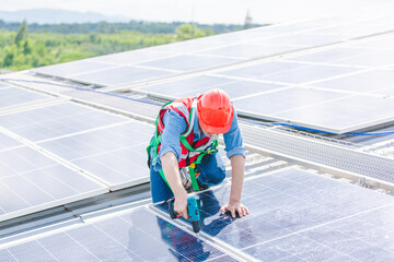 Male professional engineer installing solar photovoltaic panel system, Electrician mounting blue solar module technology on power industrial factory roof, Alternative energy ecological technician job