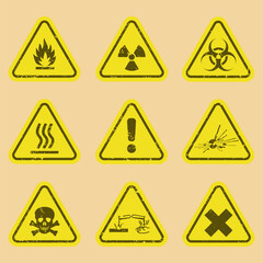 Set of warning signs on vector grunge background.  Nine Symbols of hazard warning  on cardboard background. Explosive material, Flammability substance, Corrosive substance. EPS10.