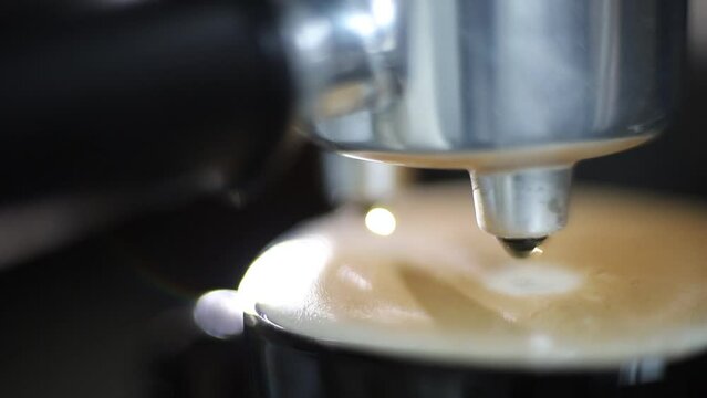 cappuccino close-up drops dripping in coffee machine