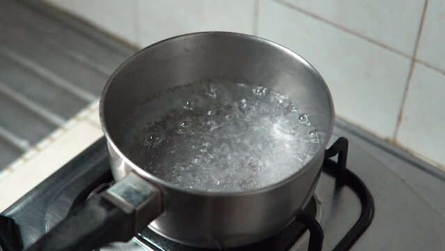 Boiling water, Close up in a pot of boiling water, Boiling water bubbles. selective focus