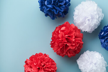 4th of July background. USA paper fans, Red, blue, white stars and confetti on blue wall...