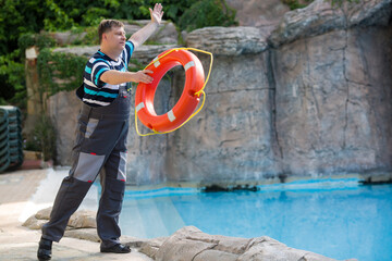 A man throws a lifebuoy to a drowning man.