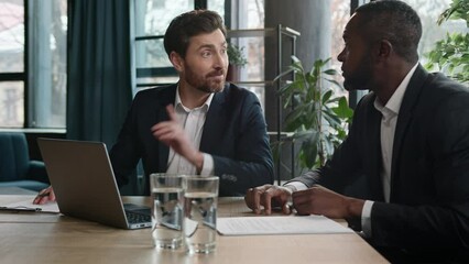 African American employer share business idea Caucasian man excited support two diverse men multiracial office coworkers businessmen meeting talking discuss laptop startup negotiate smiling laughing