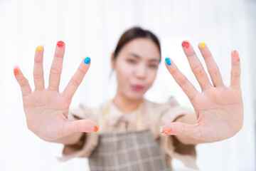 happy pretty woman cook and bake bakery with colorful color on finger hand to decorate and paint...