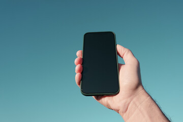 hand holding a mobile phone, mobile phone addiction