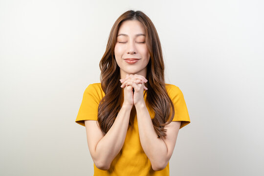 Young woman praying to holy god isolated on background