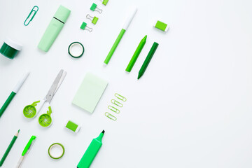 Set of green stationery for work and study on white background. Back to school. Top view, flat lay, copy space