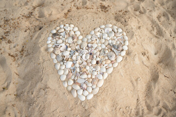 Heart made of shells on the sand
