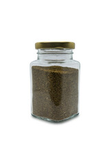 Celery seeds in a glass jar with closed lid. Isolated on white with clipping path.