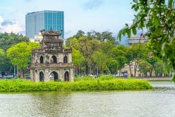 Fototapeta na wymiar Hoan Kiem Lake ( Ho Guom) or Sword lake in the center of Hanoi in the morning. Hoan Kiem Lake is a famous tourist place in Hanoi. Travel and landscape concept.