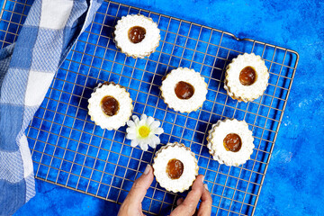 hand holding a Traditional algerian cookies with apricot jam named in french sablé for eid mubarak