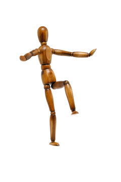 Wooden brown mannequin in motion.
