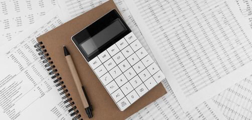 Naklejka na ściany i meble Calculator with notebook on financial documents. Financial concept.