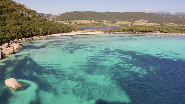 4k drone flight back footage (Ultra High Definition) of popular tourist destination - Santa Giulia beach. Nice morning seascape of Mediterranean sea. Splendid scene of Corsica island, France.
