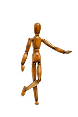 Wooden brown mannequin stands with its leg raised white isolate background.
