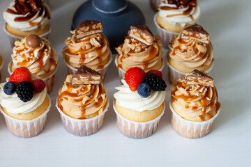 Salted Caramel Cupcakes with bites of chocolate and vanilla cupcakes with fresh berries