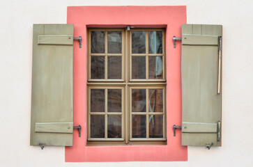 View of old building with wooden window and shutters