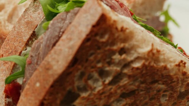 American pastrami sandwich in New York ham meet cuts. chef cooking Famous thick cut sous vide beef sandwich on restaurant cafe kitchen.