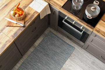 Stylish rug on floor in modern kitchen