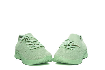 Summer green casual sneakers made of mesh fabric, on a white background, isolated.