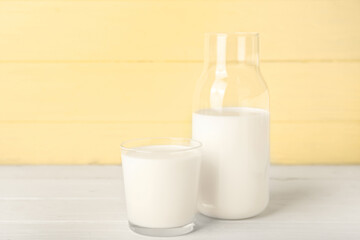 Bottle and glass of fresh milk on table