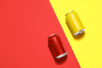 Metal cans of soda on color background