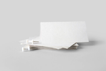 White sticky notes with pins on grey background