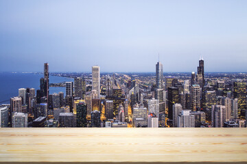 Blank table top made of wooden planks with beautiful Chicago cityscape at night on background, mockup