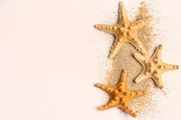 Fototapeta na wymiar Starfishes with sand on white background