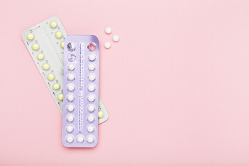 Oral contraceptive pills on pink background
