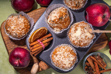 Apple pie crumble streusel muffins, Sweet autumn baking pastry with red apple slices, cinnamon and spices and crumble toppings
