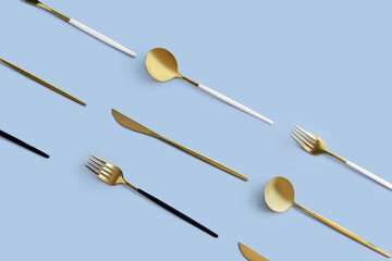 Golden cutlery on blue background