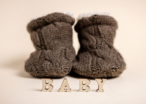 baby boy clothes on rope,blue blanket bow and bodysuit,dry cotton.word baby from wooden letters,baby shower or its a girl.toddler infant booties knitted pattern.eco blocks.ultrasound picture of fetus.