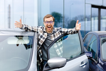 Great Car. Cheerful guy standing near auto, gesturing thumbs up buying vehicle in dealership center - Powered by Adobe