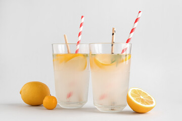 Glasses with fresh lemonade on grey background
