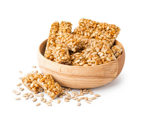 Bowl with tasty kozinaki and sunflower seeds on white background