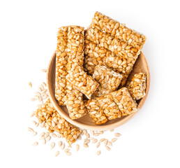 Bowl with tasty kozinaki and sunflower seeds on white background