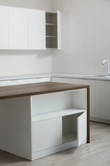 Interior of light kitchen with white drawers