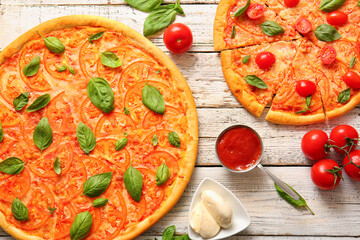 Tasty pizzas margarita on white wooden background