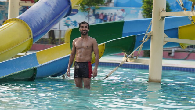a asian indian man in water park holidays fun stock images