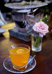 Honey ginger tea in a clear glass cup                               
