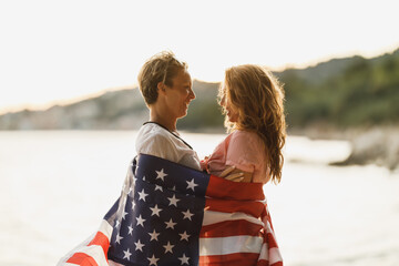 Two Women With American National Flag Spending Day On A Beach