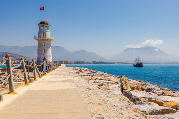 Lighthouse and ship in harbour Alanya, Antalya, Turkey. Sunny summer