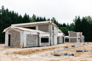 Fototapeta na wymiar construction of a private modern block energy-efficient house in a green forest quarter