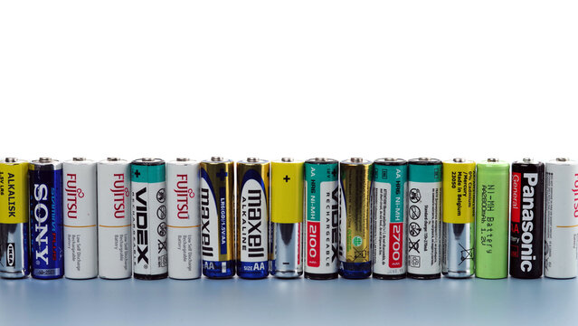 Kyiv, Ukraine - May 20, 2023: Many used and damaged primary and  secondary batteries from different manufacturers stand in a row..