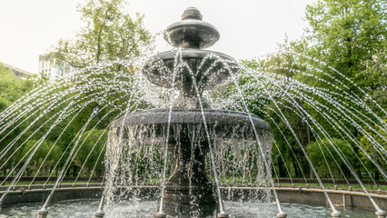 Round fountain in the city park in summer day