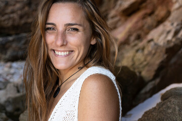 Young Caucasian woman laughs happily on the beach