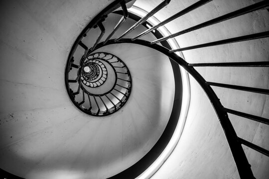 Old vintage spiral staircase. Black and white photography. - Powered by Adobe