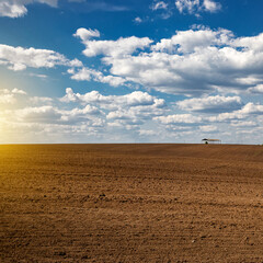 Plowed field before sowing on a sunny day.