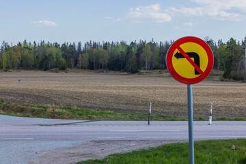 Close-up view of road sign forbidding left turn. 